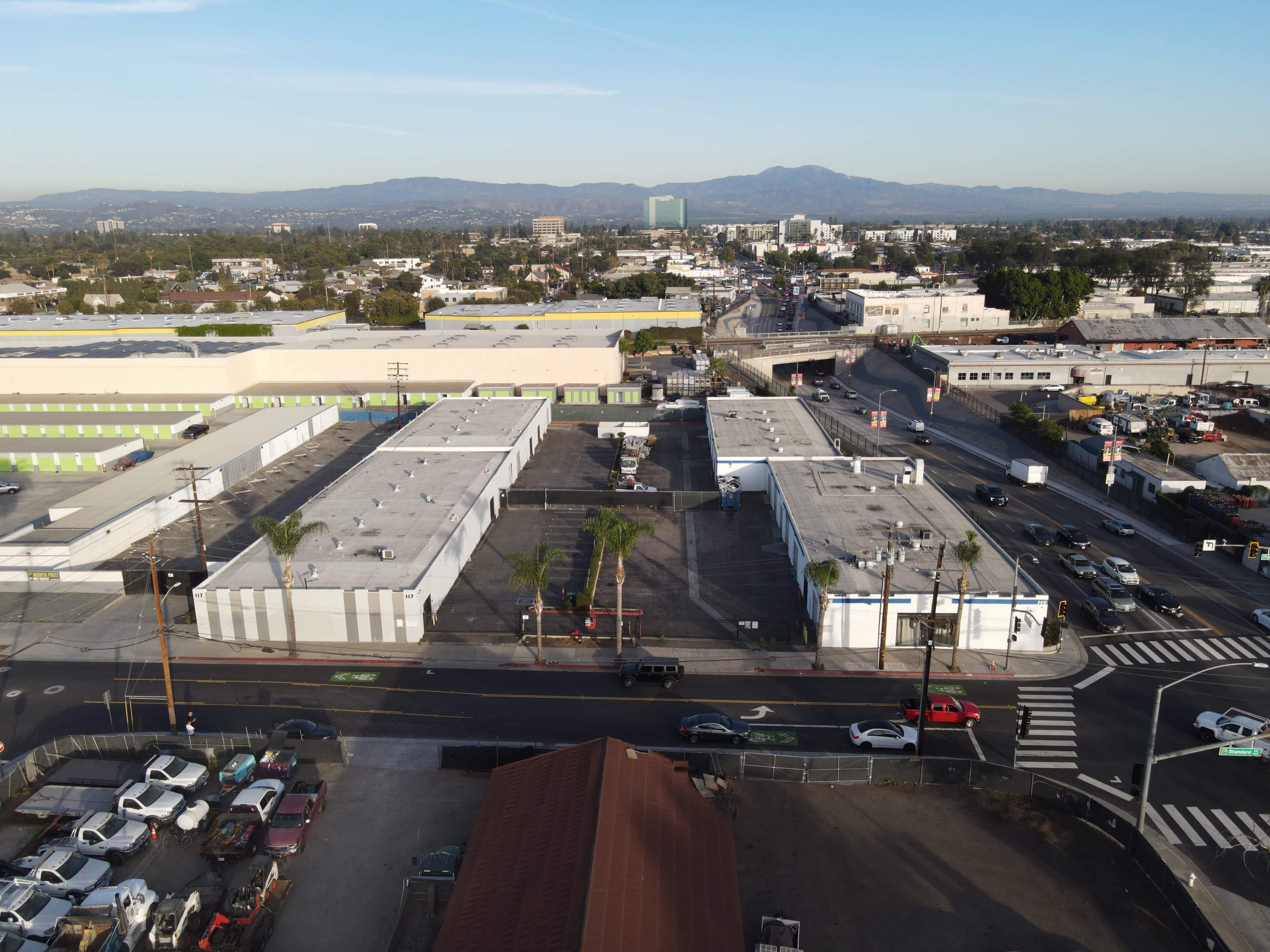 Aerial view of the Next Package facility with the Southern California skyline and mountains